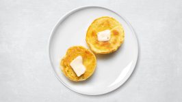 Two toasted keto bread halves with butter