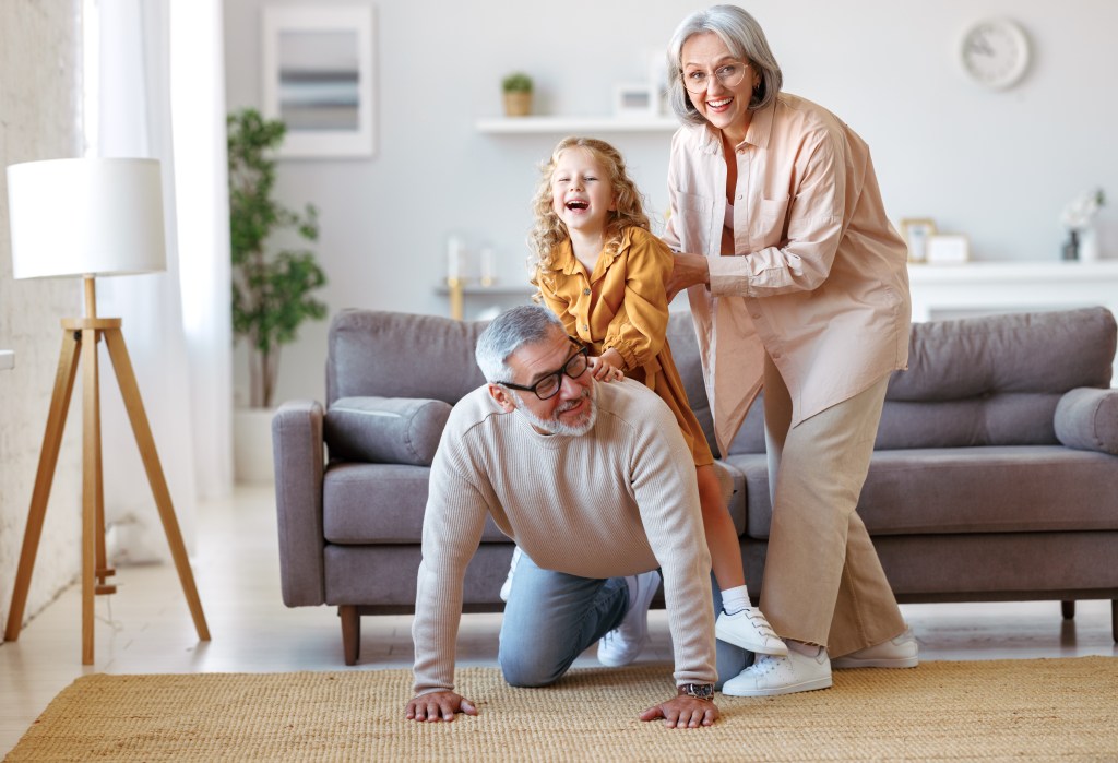 Older couple playing with a grandchild