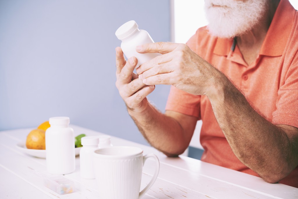Man reading supplement label