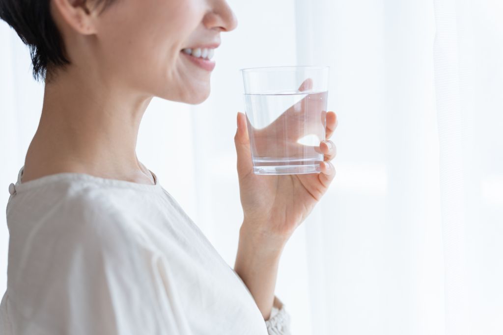 Woman holding glass of water