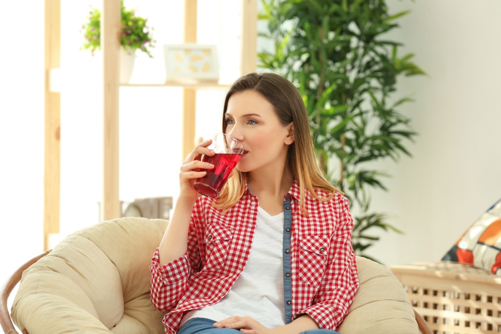 Woman drinking cranberry juice