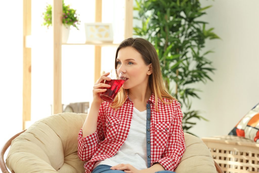 Woman drinking cranberry juice