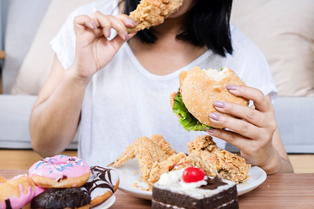 Woman eating junk food   