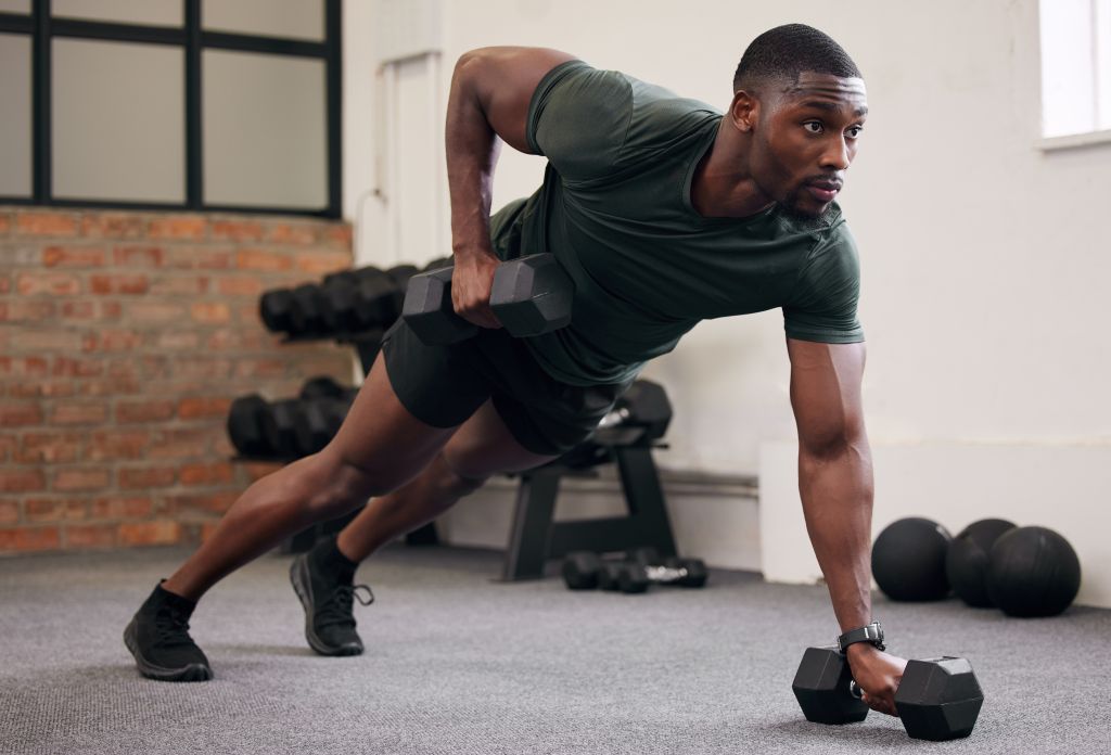 Young fit man lifting weights