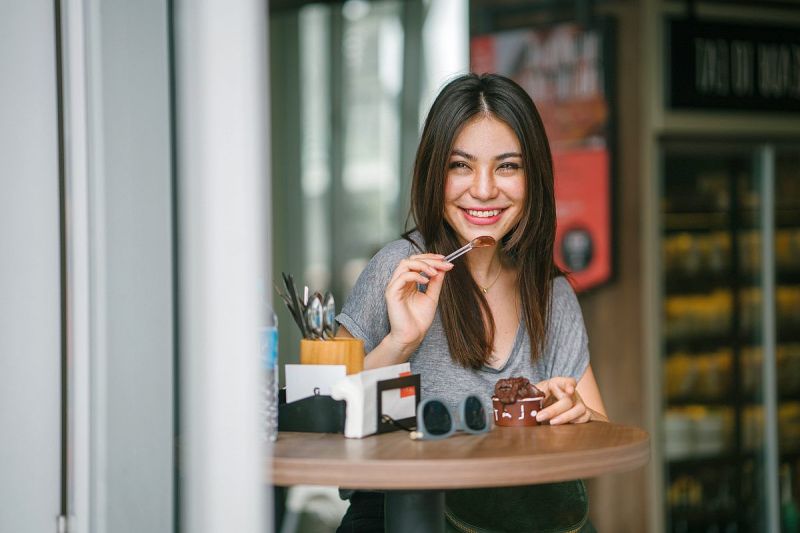 Young woman sitting at the table eating chocolate ice cream | Dr. Berg's Keto Recipes | Breakfast, Lunch, Dinner, And Dessert