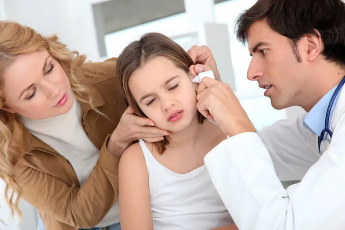 Young girl having her ear checked by a doctor. | The Best Remedy for An Ear Infection
