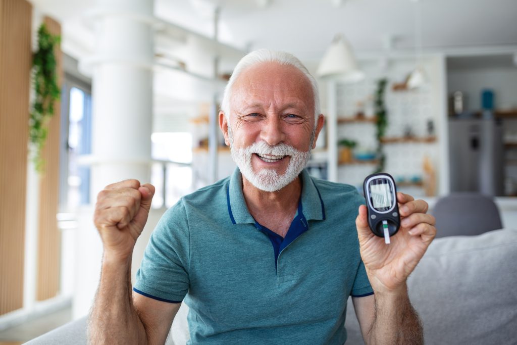 Man holding blood sugar meter
