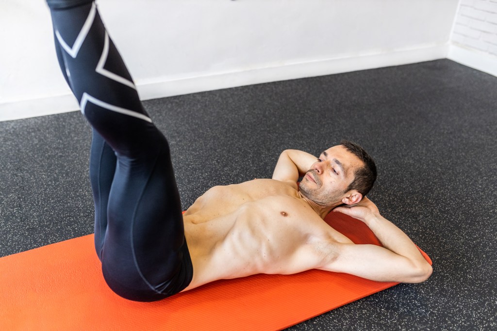 Young man doing leg lifts