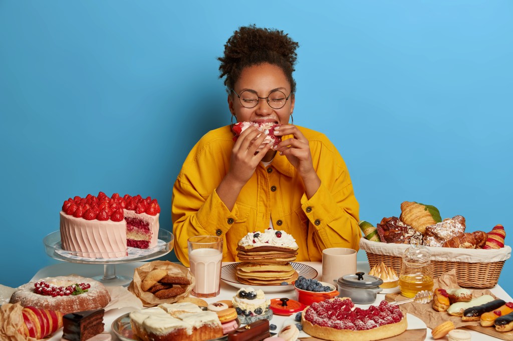 Woman eating sugary foods 


