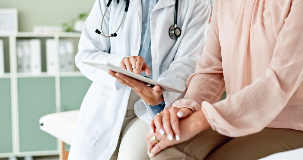 Woman talking to doctor