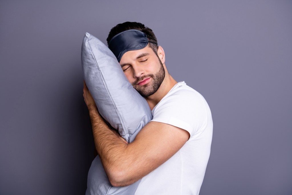 sleep mask, man, and pillow