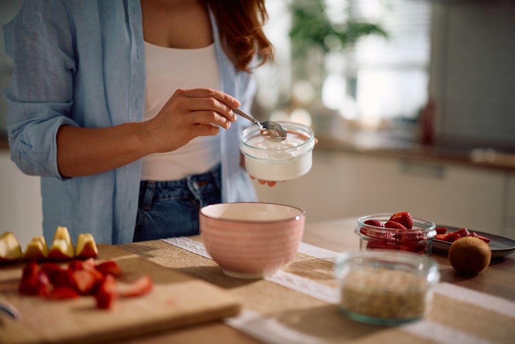 Women preparing a bowl of yogurt