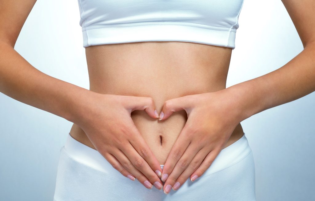 Woman with hands on stomach