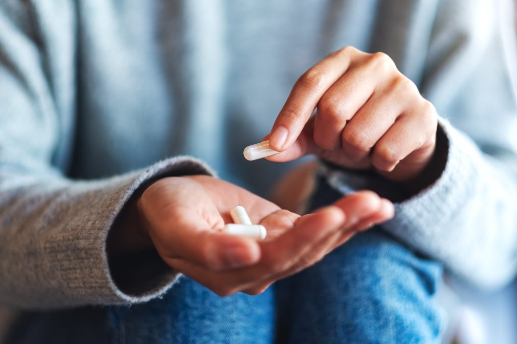 Hand holding capsules  