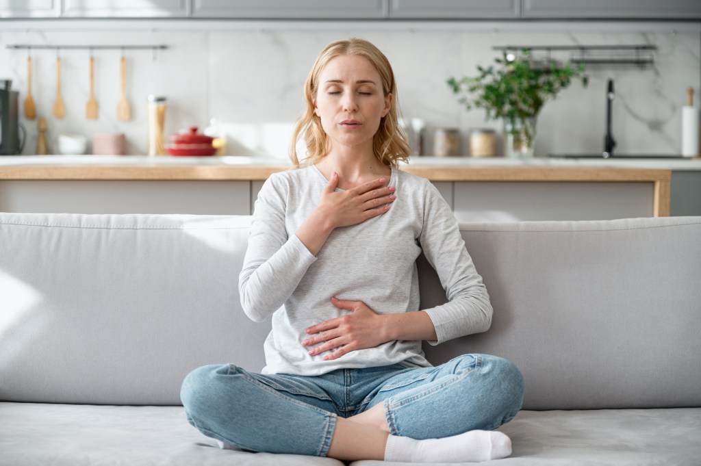 Woman performing a deep breathing exercise