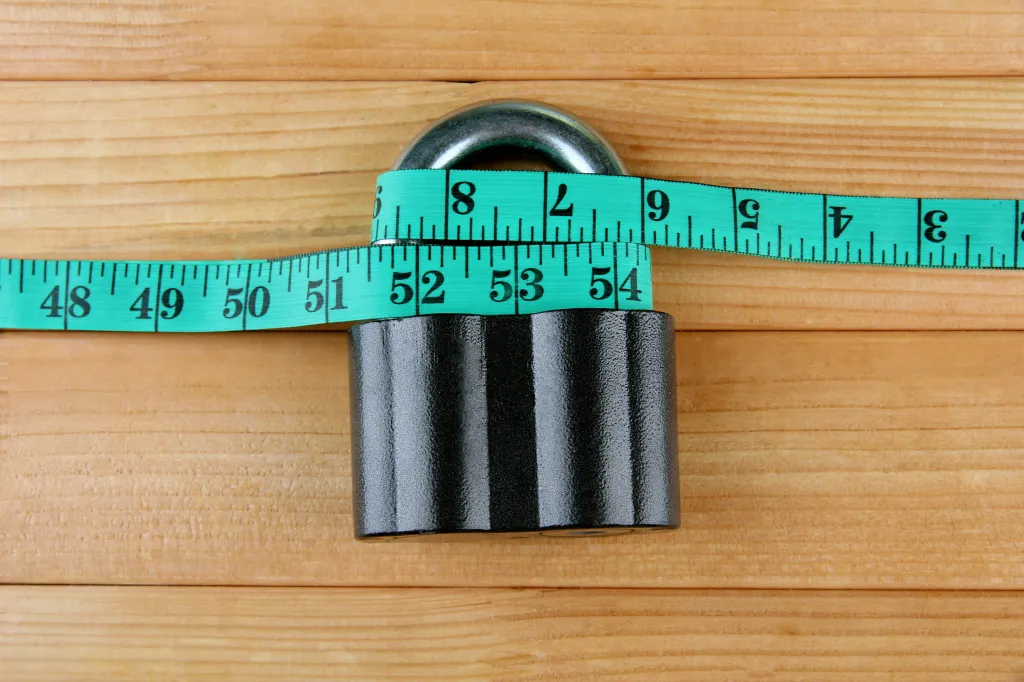 Lock with a measuring tape around it