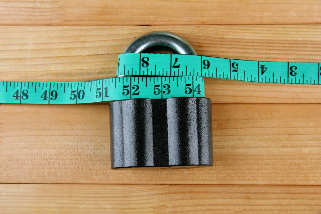 Lock with a measuring tape around it