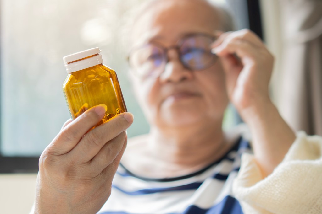 Women looking at a vitamin bottle