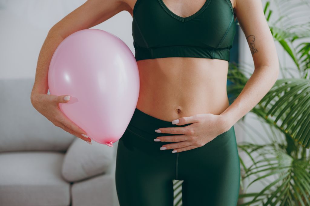 Women feeling bloated with a balloon