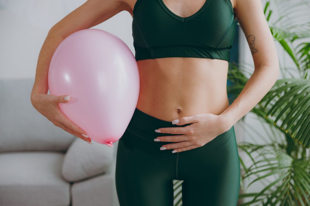 Women feeling bloated with a balloon