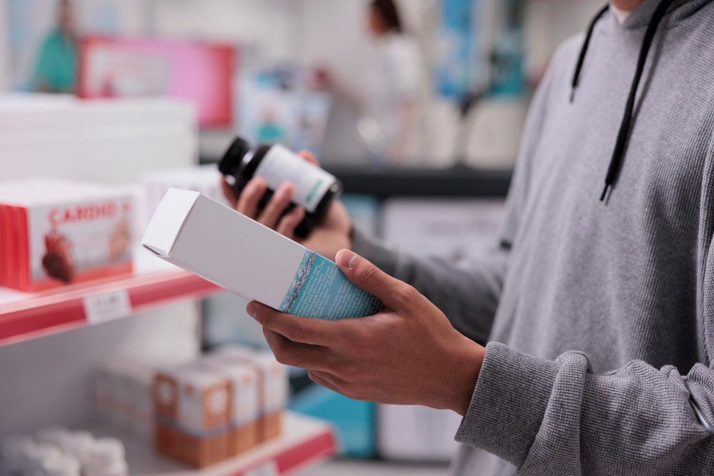 Woman comparing two supplements