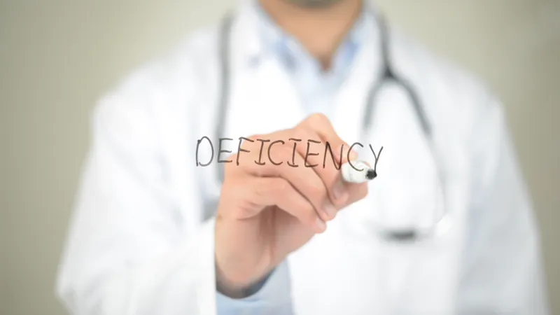 Vitamin K deficiency, Doctor writing on transparent screen