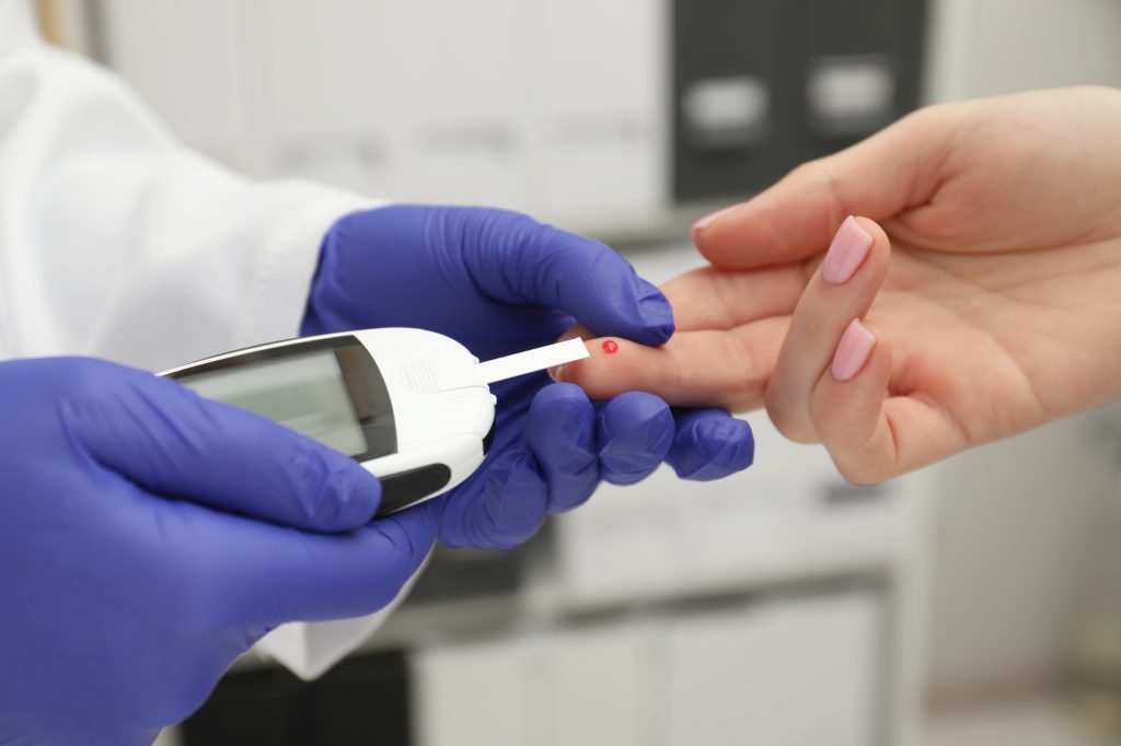 Doctor checking blood sugar