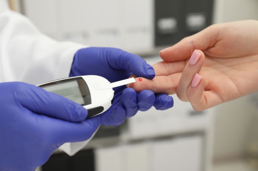 Doctor checking blood sugar