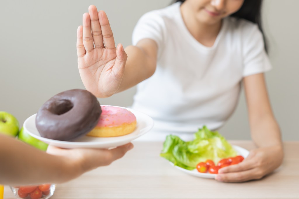 Woman saying no to dessert