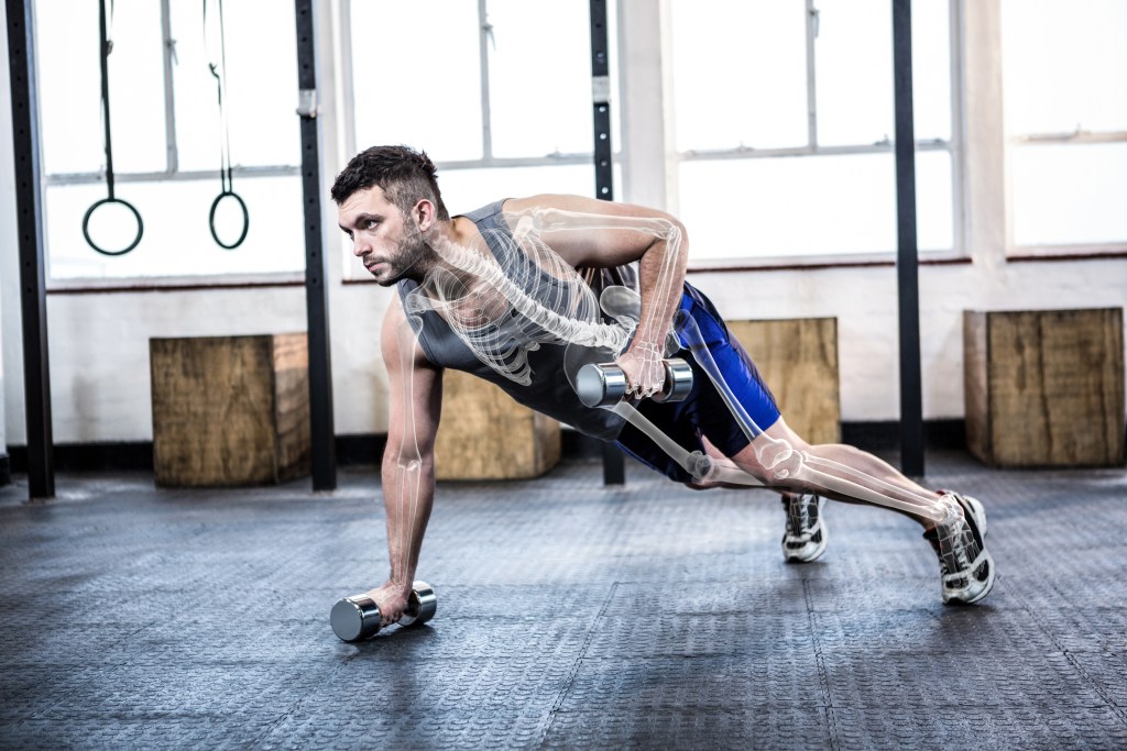 a man doing push ups with weights