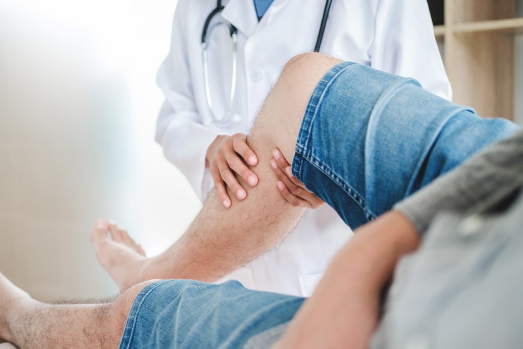 Doctor examining leg 