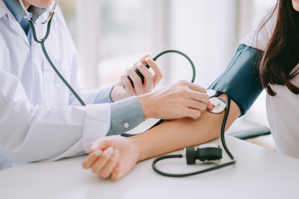 Doctor checking patient's blood pressure