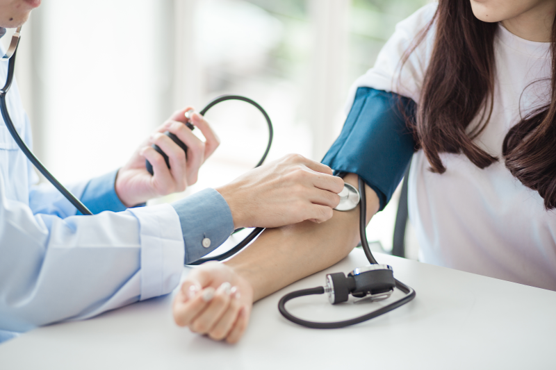 Doctor checking blood pressure