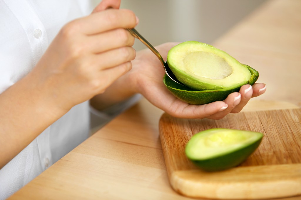Women preparing to eat avocado