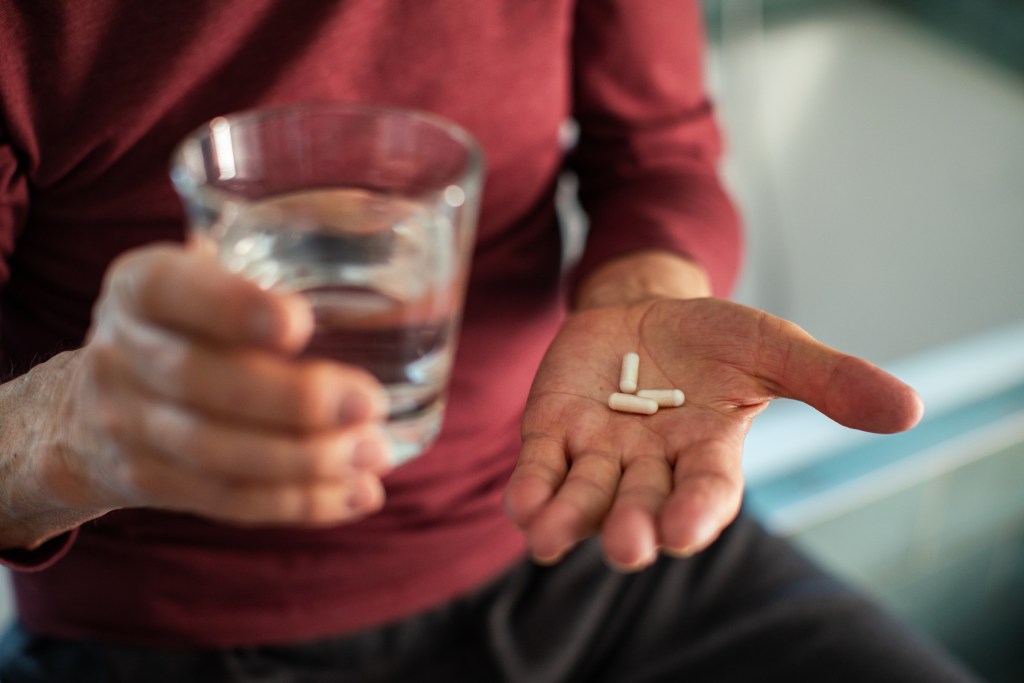 Man holding a supplement   