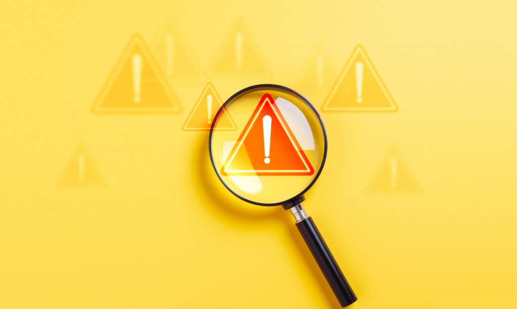 Magnifying glass with an exclamation mark