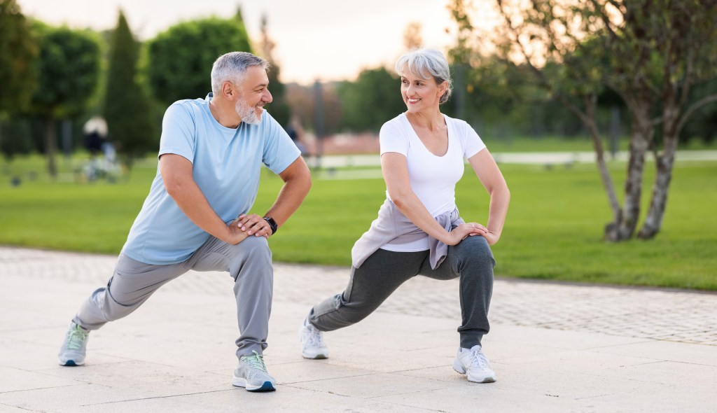 Older couple exercising outside