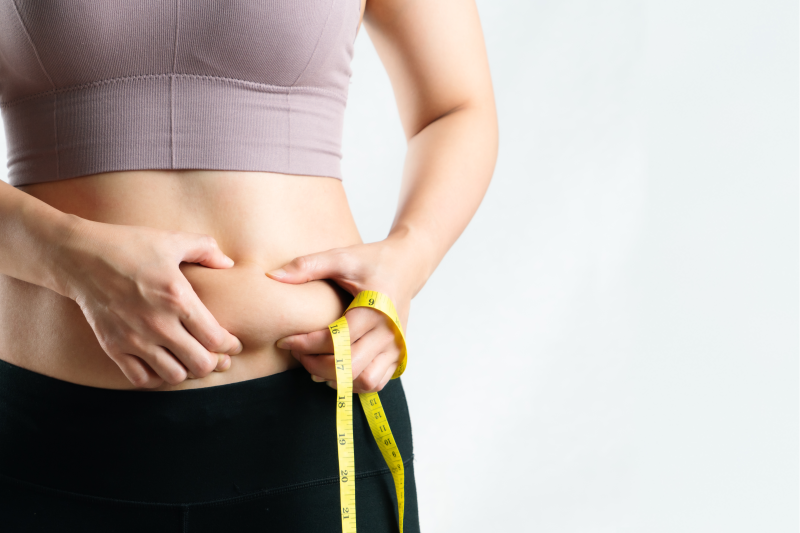 Woman pinching her belly fat
