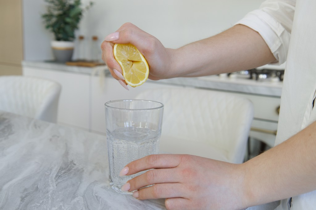Woman squeezing lemon