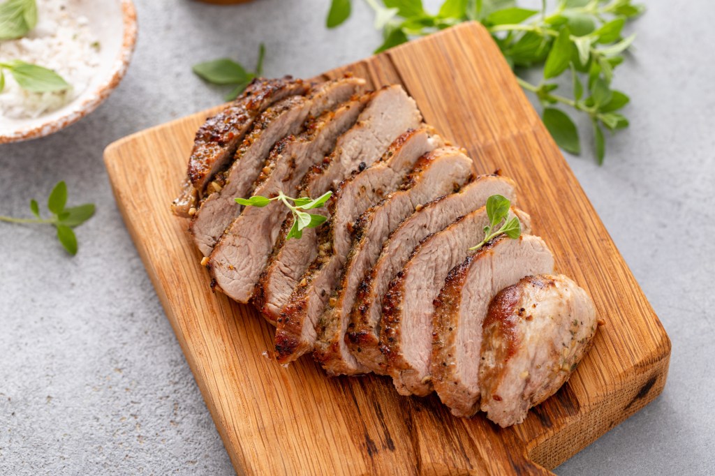 Sliced pork on cutting board