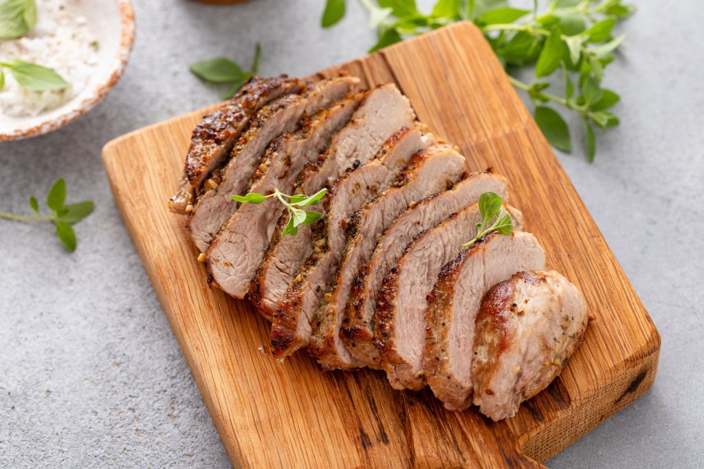 Sliced pork on cutting board