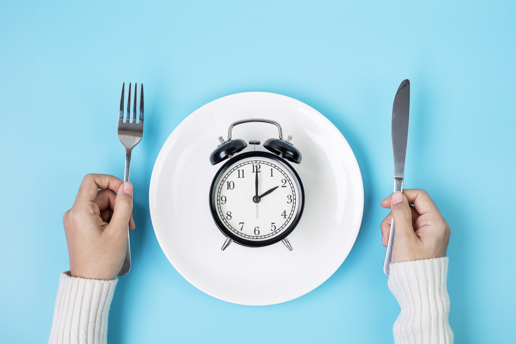 Plate with a clock and a fork and knife