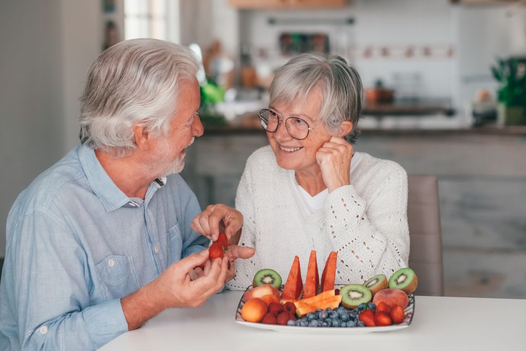 Senior couple eating fruits