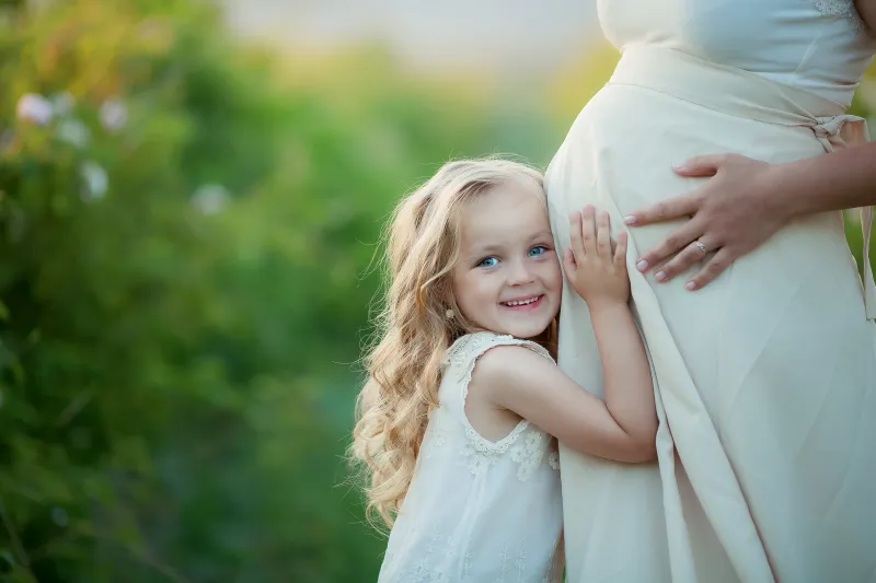Pregnant woman and little girl
