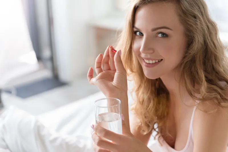 Woman holding krill oil capsule