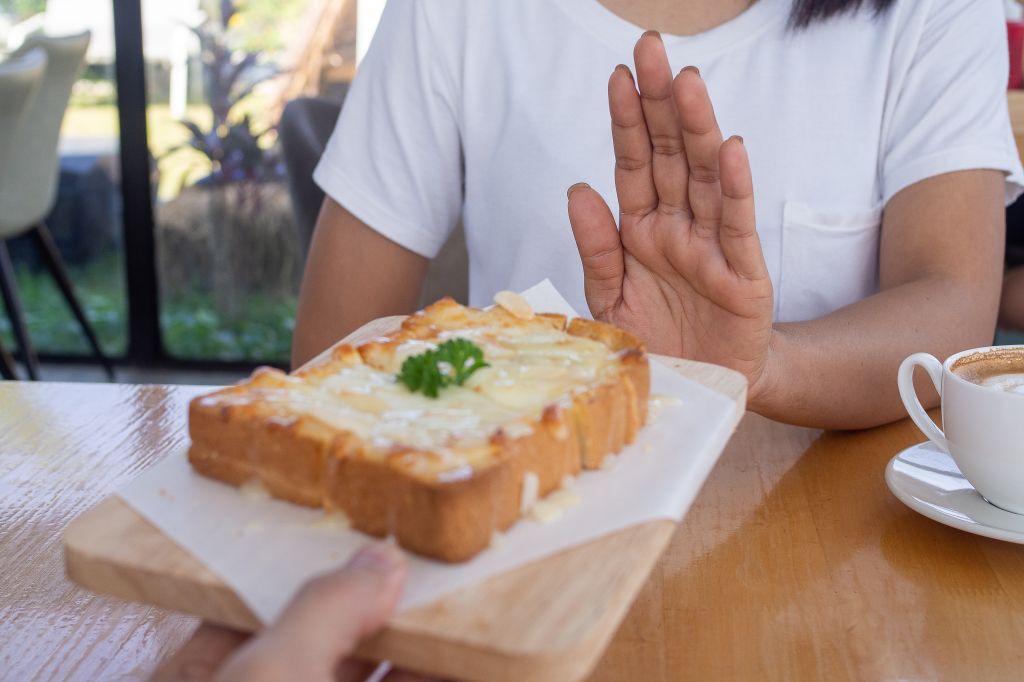Woman declining cheese bread