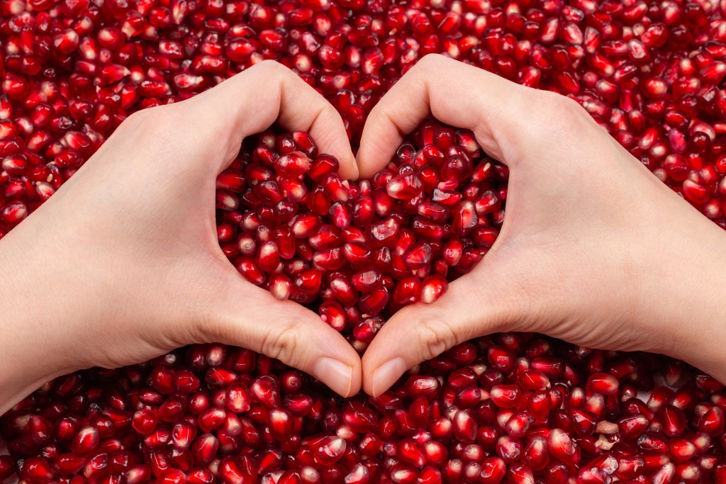 Heart symbol on pomegranate seeds