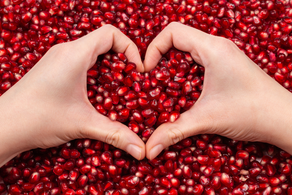 Heart symbol on pomegranate seeds