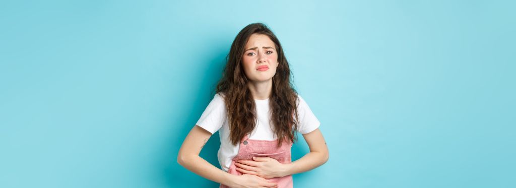 Woman holding her stomach 