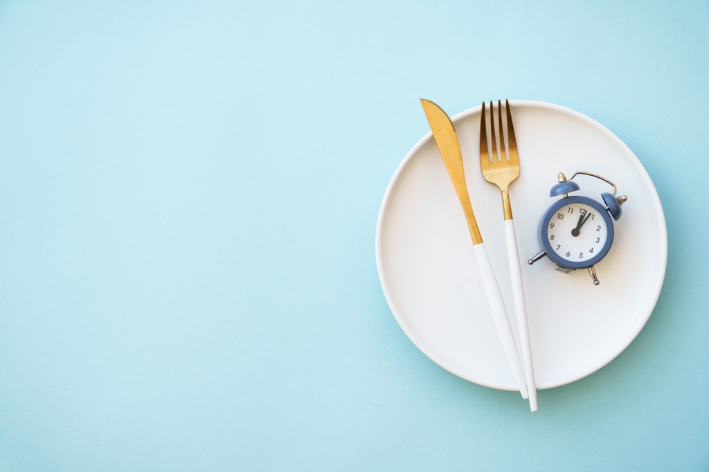 fasting concept alarm clock plate